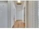 Bright hallway with wood floors leads to other rooms in this well-maintained home at 3004 Spring Hammock Dr, Plant City, FL 33566