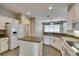 Well-equipped kitchen featuring an island, tile floors and stainless steel appliances at 3004 Spring Hammock Dr, Plant City, FL 33566