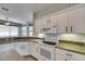 Kitchen with white cabinets, stainless appliances, tile backsplash and breakfast nook at 3004 Spring Hammock Dr, Plant City, FL 33566
