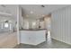 Inviting kitchen with breakfast bar seating and tile floors open to the living spaces at 3004 Spring Hammock Dr, Plant City, FL 33566