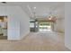 Spacious living room with neutral carpet, tray ceiling, and sliding glass doors to the outdoor area at 3004 Spring Hammock Dr, Plant City, FL 33566