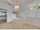 Bright living room with neutral carpet, recessed lighting and access to kitchen and lanai at 3004 Spring Hammock Dr, Plant City, FL 33566