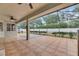 Large screened patio features tile flooring, ceiling fans, and backyard views at 3004 Spring Hammock Dr, Plant City, FL 33566