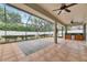 Screened patio with ceiling fans and a built-in outdoor kitchen space at 3004 Spring Hammock Dr, Plant City, FL 33566