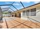 Spacious screened patio with tile flooring and ceiling fan, perfect for outdoor entertaining and relaxation at 3004 Spring Hammock Dr, Plant City, FL 33566