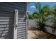 Backyard showing the outdoor shower with a tropical palm in the background at 302 W Hilda St, Tampa, FL 33603
