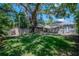 Large backyard with shade, lush green lawn, shade structure, and perimeter fence at 302 W Hilda St, Tampa, FL 33603