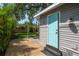 Private backyard features a wood deck, shade, and tropical landscaping at 302 W Hilda St, Tampa, FL 33603