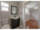 Bathroom features a vanity with a dark cabinet and a view to the bedroom at 302 W Hilda St, Tampa, FL 33603