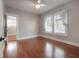 Bright bedroom with hardwood floors, neutral paint, ceiling fan, and natural light at 302 W Hilda St, Tampa, FL 33603