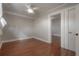 Bedroom with hardwood floors, white ceiling, ceiling fan, and open doorway at 302 W Hilda St, Tampa, FL 33603