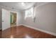 Cozy bedroom showcasing hardwood floors, neutral paint, and ensuite bathroom access at 302 W Hilda St, Tampa, FL 33603