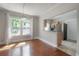 Sunlit dining room with hardwood floors and a stylish chandelier, open to the adjacent kitchen at 302 W Hilda St, Tampa, FL 33603