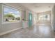 Bright sunroom with tile flooring, large windows, and a charming blue front door at 302 W Hilda St, Tampa, FL 33603
