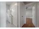 Hallway view showcasing bathroom, hardwood floors, and multiple doorways enhancing flow at 302 W Hilda St, Tampa, FL 33603