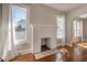 Bright living room with a decorative fireplace and large windows with white curtains at 302 W Hilda St, Tampa, FL 33603