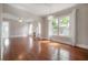 Open-concept living room with hardwood floors, fireplace, and stylish light fixtures at 302 W Hilda St, Tampa, FL 33603