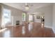 Sun-drenched living area with hardwood floors, fireplace, and modern ceiling fan at 302 W Hilda St, Tampa, FL 33603