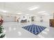 Expansive basement with garage door, white floors, and ample storage area at 3087 Cherry Ln, Clearwater, FL 33759