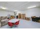 Bright basement has a round table with red chairs and storage area at 3087 Cherry Ln, Clearwater, FL 33759