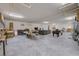 Spacious basement with concrete floors features a gray couch, pool table, and storage areas at 3087 Cherry Ln, Clearwater, FL 33759