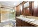Modern bathroom featuring a vanity, decorative mirror, and shower-tub combination at 3087 Cherry Ln, Clearwater, FL 33759