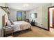 Bright bedroom with a wall mounted television and shuttered window with a view at 3087 Cherry Ln, Clearwater, FL 33759
