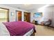 Bedroom featuring a TV, closet, ensuite bath, and cozy seating for relaxation at 3087 Cherry Ln, Clearwater, FL 33759
