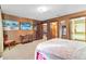 Well-lit bedroom with neutral tones, a large bed, decorative artwork, and closet access at 3087 Cherry Ln, Clearwater, FL 33759