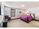 A cozy bedroom with a large window, comfortable chair, and TV for entertainment at 3087 Cherry Ln, Clearwater, FL 33759