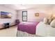 Cozy bedroom featuring a comfortable bed, TV, stylish furnishings and decor at 3087 Cherry Ln, Clearwater, FL 33759