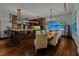 Modern dining area featuring a large wooden table with seating, open to the kitchen with bar stool seating at 3087 Cherry Ln, Clearwater, FL 33759
