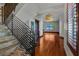 Elegant entryway featuring stone stairs, metal railings, and an inviting view of the open living space with hardwood floors at 3087 Cherry Ln, Clearwater, FL 33759