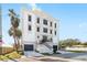Elegant three-story home boasts a unique architectural design, dual garages, and meticulous landscaping at 3087 Cherry Ln, Clearwater, FL 33759
