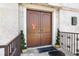 Elegant arched double doors, festive decorations, and stone façade enhances curb appeal at 3087 Cherry Ln, Clearwater, FL 33759