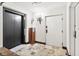 Hallway area showing elevator access, stone floors, and sconce lighting at 3087 Cherry Ln, Clearwater, FL 33759