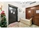 Hallway features neutral walls, a festive Christmas tree, elevator access, and a cozy cushioned bench at 3087 Cherry Ln, Clearwater, FL 33759