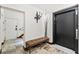 Hallway area featuring elevator access, stone floors, and sconce lighting at 3087 Cherry Ln, Clearwater, FL 33759