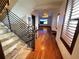 Hallway with stone staircase, wood floors, a decorative light fixture, and beach views on TV's at 3087 Cherry Ln, Clearwater, FL 33759