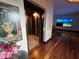 Hallway featuring a home elevator, hardwood floors, and beach scene displays at 3087 Cherry Ln, Clearwater, FL 33759