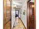 Hallway featuring stone tile floors, dark wood trim, and decorative wall art at 3087 Cherry Ln, Clearwater, FL 33759