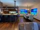 Open-concept kitchen and dining area with bar seating, modern appliances, and hardwood floors at 3087 Cherry Ln, Clearwater, FL 33759