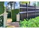 Close-up showcasing the manicured landscaping, including privacy hedges and decorative fencing at 3087 Cherry Ln, Clearwater, FL 33759