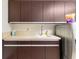 Functional laundry room featuring modern appliances, ample counter space and custom cabinets at 3087 Cherry Ln, Clearwater, FL 33759