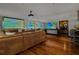 Entertainment room features a large projector screen, multiple TVs, wood floors, and modern, unique decor at 3087 Cherry Ln, Clearwater, FL 33759
