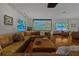 Large living area featuring a projector screen, a sectional, hardwood floors and comfortable seating at 3087 Cherry Ln, Clearwater, FL 33759
