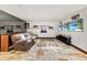 A comfortable living room with cozy seating, movie posters, and a large entertainment screen at 3087 Cherry Ln, Clearwater, FL 33759