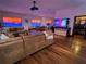 Large living room offers hardwood floors, comfortable seating, and a unique media display at 3087 Cherry Ln, Clearwater, FL 33759