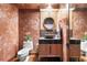 Stylish powder room with a vessel sink, wood-look vanity, decorative mirror, and unique textured walls at 3087 Cherry Ln, Clearwater, FL 33759
