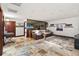 Inviting theater room boasts travertine tile, leather sofa, and movie-themed decor for entertainment at 3087 Cherry Ln, Clearwater, FL 33759